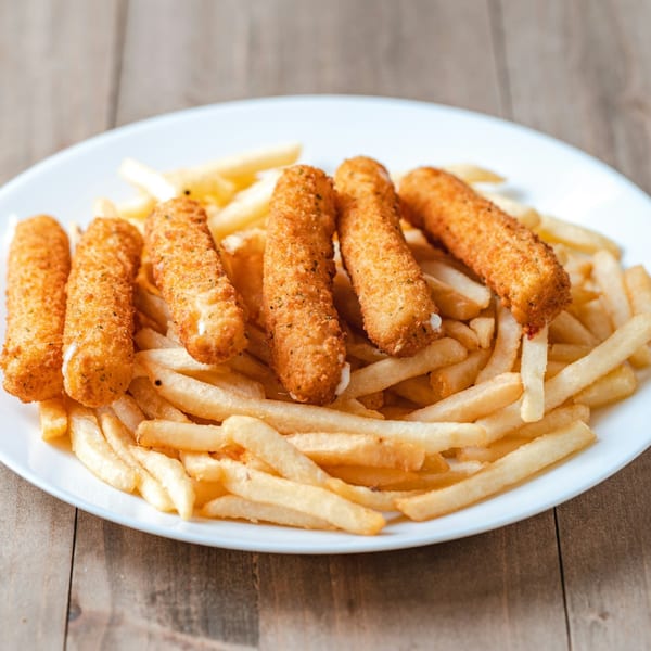 Halal mozzarella sticks and golden french fries on a white plate from New York Grill.